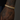 Gold bracelet with diamonds on a tattooed arm against a dark background
