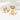 Set of gold rings with star, shell, and dolphin designs on a white background