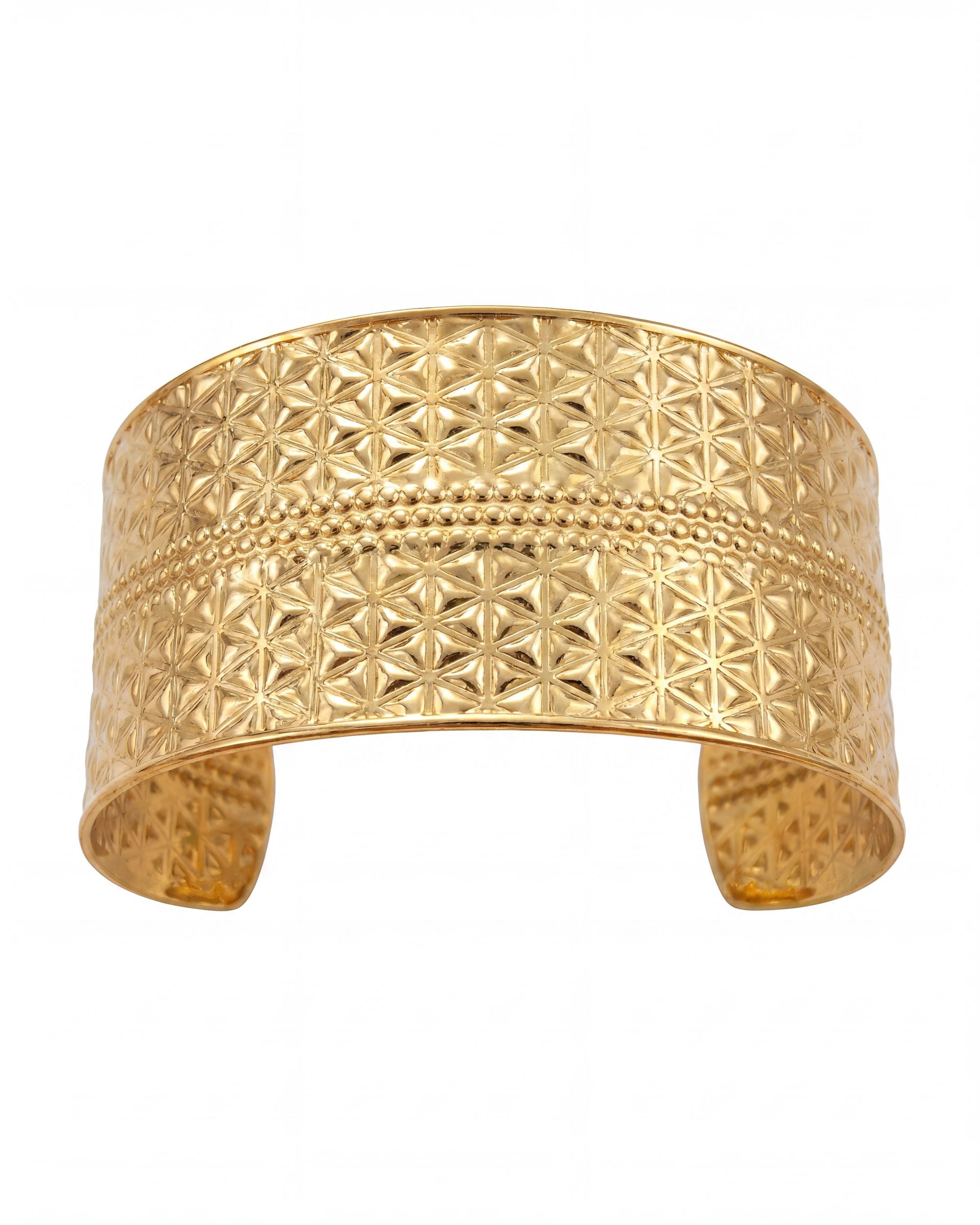 Gold cuff bracelet with geometric pattern on a white background