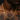 Gold chain necklace on a person with tattoos